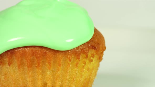 Pouring Green Glaze Over Muffin