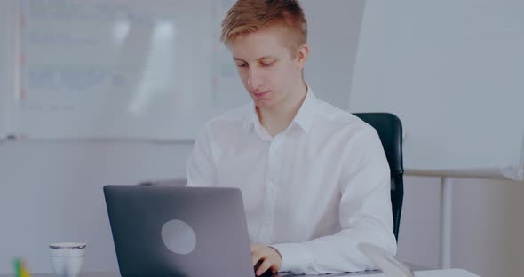 Overworked Businessman Working on Laptop