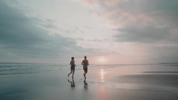 Two People Jogging at Sunset