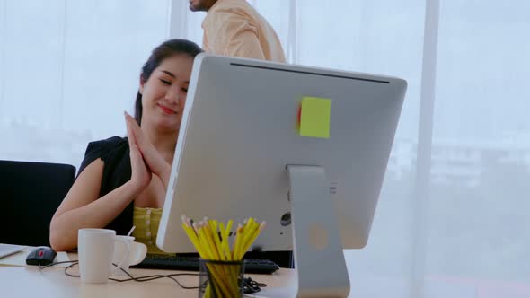 Businesswoman and Businessman Having Conversation in Modern Office