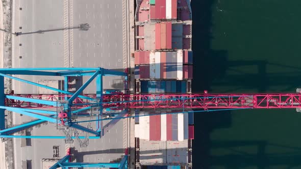 Drone Flying Over a Container Ship During Cargo Operations Over the Customs Area