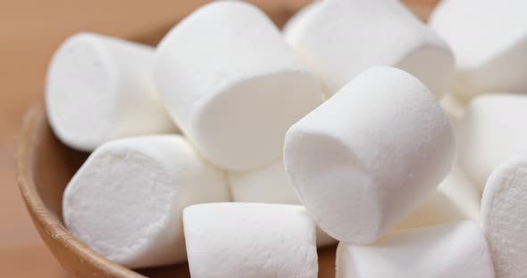 White marshmallow on wooden plate