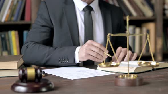 Close Up Shoot of Judge Hand Checking Document in Court Room