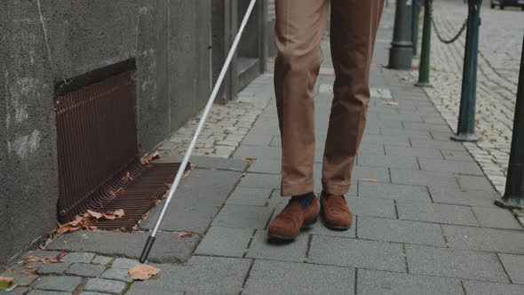 Man with Visual Disability Carrying Grocery Bag on Street