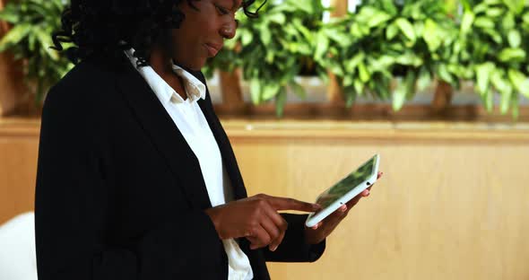 Businesswoman using digital tablet in office