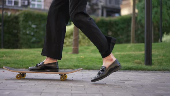 Side View Legs of Unrecognizable Male Skater Riding Skateboard in Slow Motion Outdoors