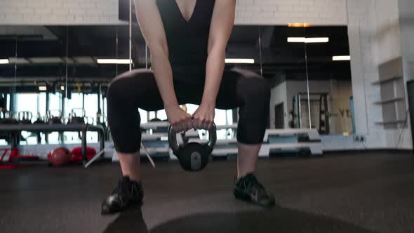 Strength Training Sporty Female Perform Explosive Lifting Kettlebell Muscle Training with Weighting