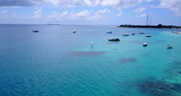 Tropical flying copy space shot of a summer white paradise sand beach and blue water background 