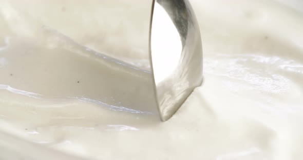 Macro slow motion of vanilla ice cream with scoop