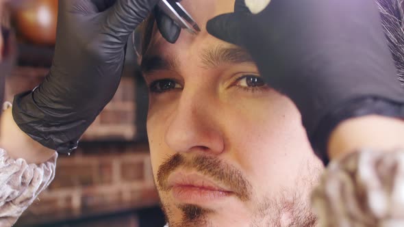 Young Stylish Man in a Beauty Salon. Face and Eyebrow Care