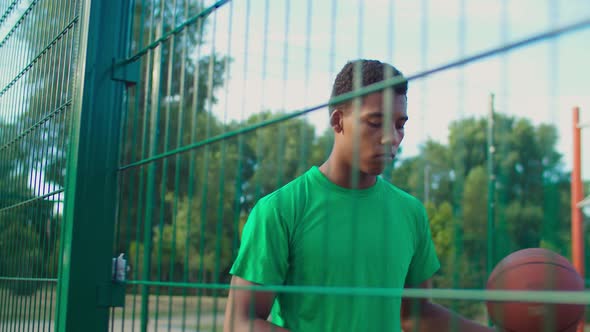 Basketball Player Juggling Ball at Outdoor Court