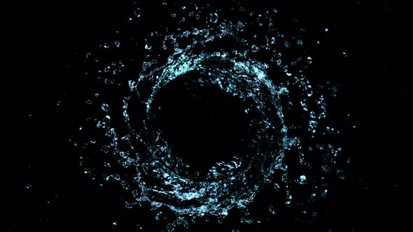 Super Slow Motion Shot of Rotating Water Splash Isolated on Black Background at 1000Fps.