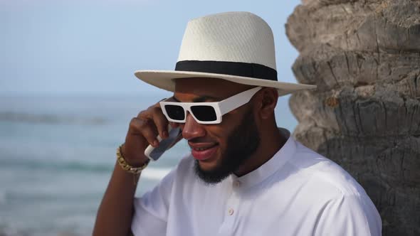 Closeup of Busy Troubled African American Successful Man Talking on the Phone with Blue Waves of