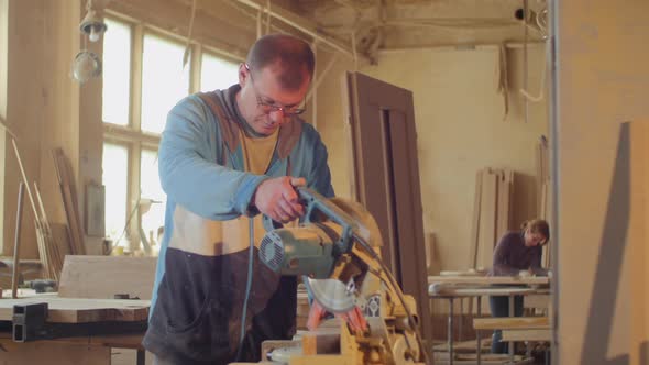 Carpenter cutting wood