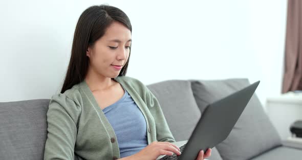 Woman working on laptop computer at home