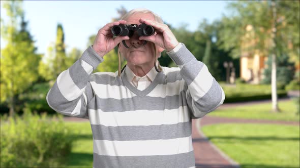 Elderly Person with Binoculars Outdoors.