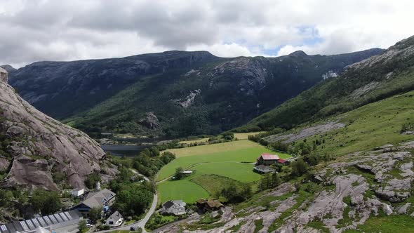 Stunning View of a Mountain Range in Norway with a Farm on the Hills