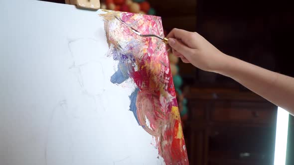 Young Girl Using a Palette Knife Paint Colorful Picture Close Up Shot