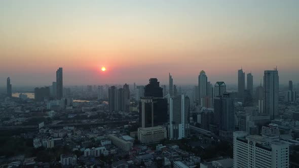 Sunset over Bangkok Skyline and Chao Phraya River, aerial view