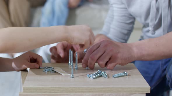 Boy and Father Sorting Screws alt