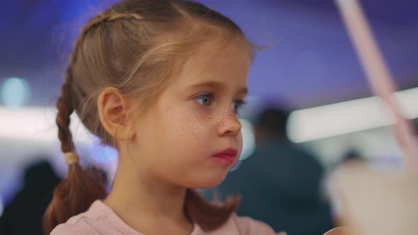 Little Girl with Pigtails Eating Fried French Fries