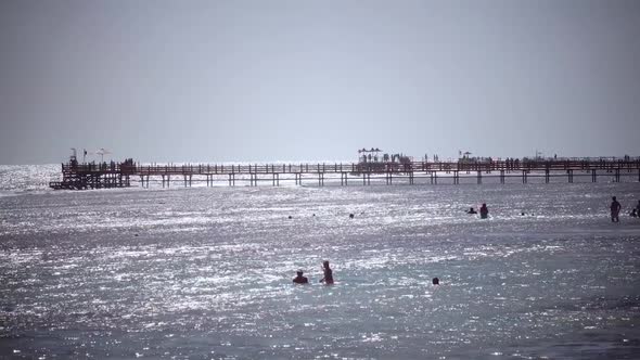 Children Bathe in the Ocean and on the Dock People Breathe the Sea Breeze