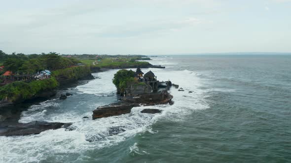 Wide Aerial Dolly Shot of Isolated Empty Tanah Lot Temple During Dangerous Weather
