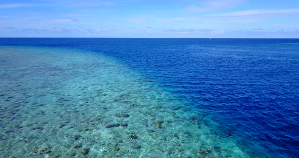 Luxury flying abstract shot of a summer white paradise sand beach and blue water background 