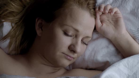 Woman Waking Up on Bed