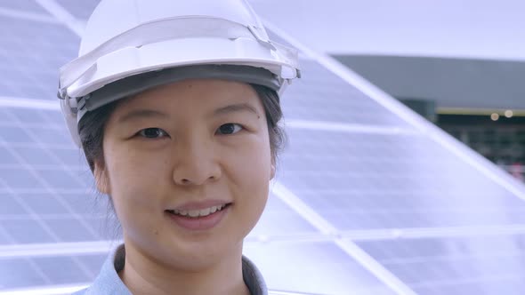 Outdoors, close up portrait of Asian female engineer and solar roof concept.