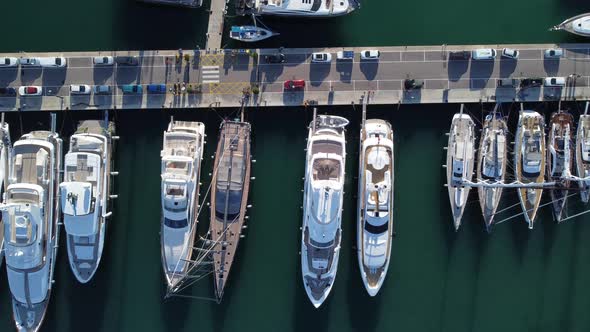 Luxury Yachts And Sailboats Docked At The Marina With Parked Cars In Palma De Mallorca, Spain. aeria