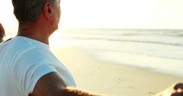 Smiling senior man standing on beach