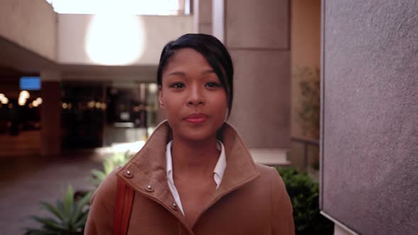 Mixed ethnicity business woman walking