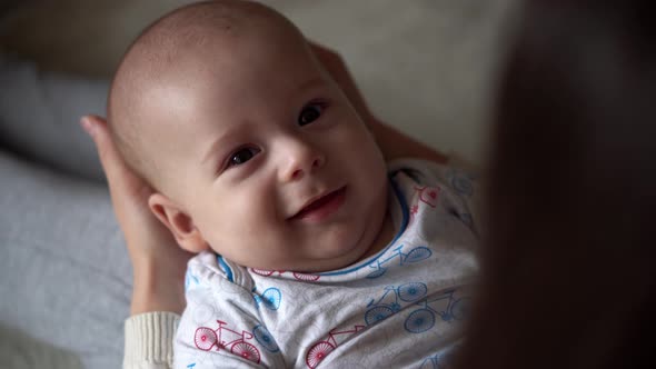 Newborn Baby With Young Mom Look Into Each Other Eye