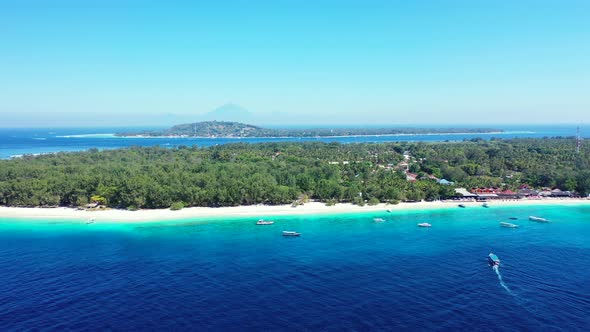 Tropical birds eye tourism shot of a paradise sunny white sand beach and blue water background 