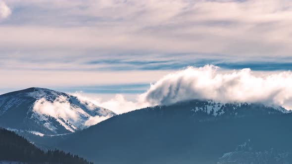 Misty clouds Motion Fast over Snowy Mmountains in Sunny Winter Alps Nature