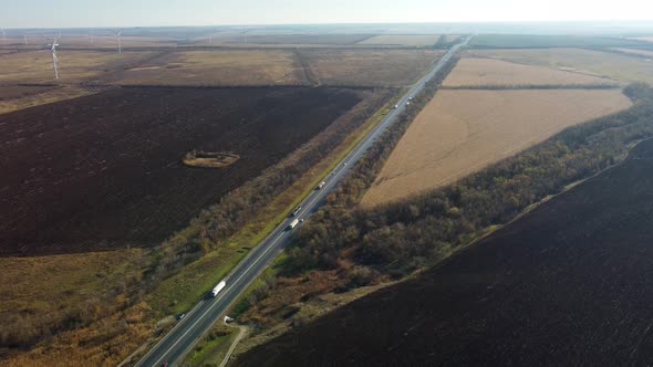 Highway on the Background of Wind Turbines and Blue Sky