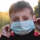 Child Boy Takes Off His Medical Mask Outdoors - VideoHive Item for Sale