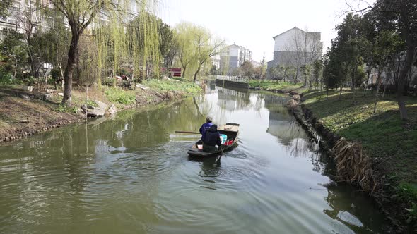 A Group Of Elderly Couples Rowing A Boat In A Small River V3