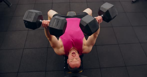 Bodybuilder Training With Dumbbells In The Gym. Top View