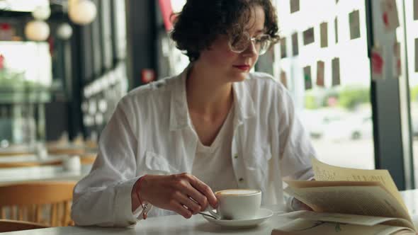 Young Beautiful Girl Sits In Cafe Restaurant Reads Book Drinks Coffee Leisure Lunch Snack Restaurant