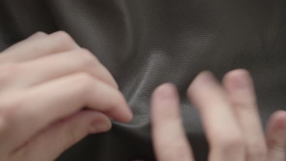 Top Down Shot of Man Hand Inspecting Soft Gray Leather