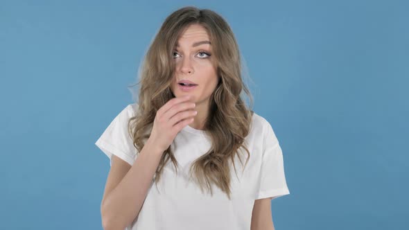 Young Girl Sneezing Isolated on Blue Background