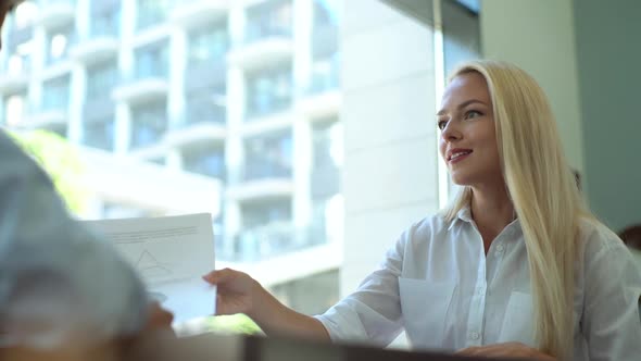 Closeup of Attractive Young Businesswoman Manager Talking About Business Tasks with Colleague