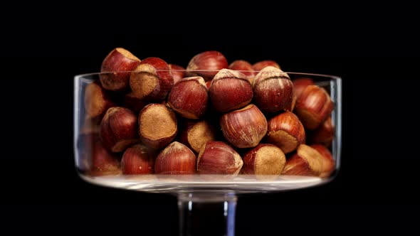 Bowl Full of Raw Peeled Hazelnuts Turns on Black Background