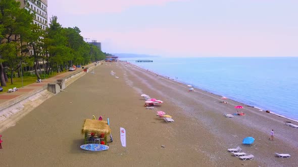 View from drone to beach along sea with green vegetation. Georgia. Kobuleti.