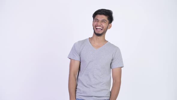 Young Happy Bearded Indian Man Laughing and Pointing Finger