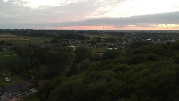 Drone shot of a cinematic rural landscape at sunset.