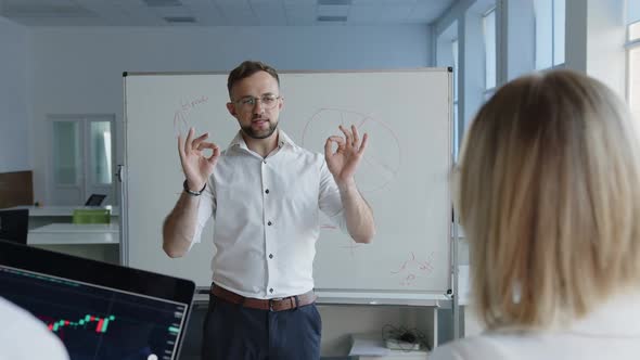 Man Explains to His Colleagues Some Moments of Work