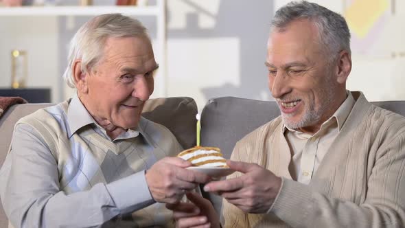 Senior Man Presenting Birthday Cake With Candle, Friendship Connection, Surprise